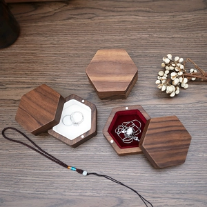 Black walnut hexagonal jewelry boxes showing inner velvet lining and storage detail