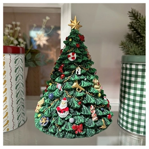Detailed close-up of a resin Christmas tree music box with hand-painted festive ornaments