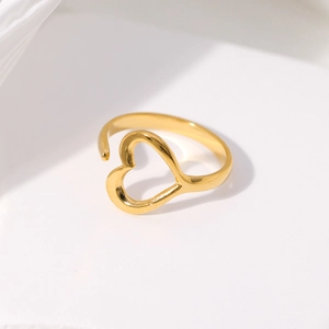 Detail of a minimalist gold hollow heart open ring showing smooth metallic texture