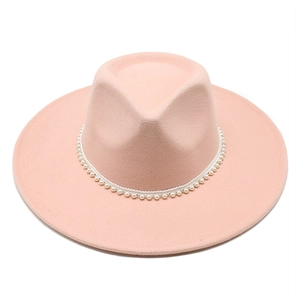 Detailed close-up of pink wool fedora hat with elegant white pearl beaded headband trim