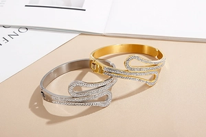 Close-up of elegant gold and silver stainless steel bangles with sparkling rhinestone inlay