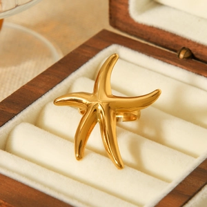 Polished gold starfish open ring made of stainless steel displayed in a luxury gift box