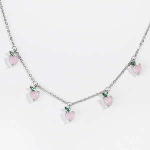 Detail view of silver chain necklace with five pink peach-shaped zircon pendants