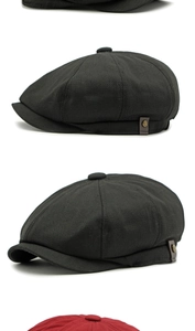 Close-up of black cotton newsboy cap with a vintage metal button and leather detail