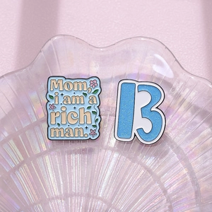 Geometric enamel brooches with floral quote and glitter number thirteen on tray