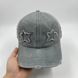 Distressed vintage baseball cap with star patches and washed denim finish in charcoal grey