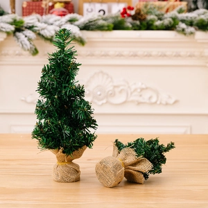 Close-up of a 30cm mini tabletop Christmas tree with burlap base and pine needles