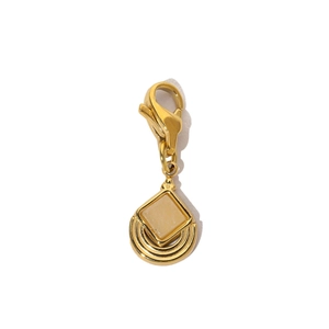 Close-up of golden stainless steel heart clasp with square beige stone charm