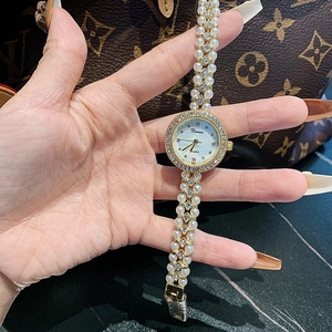 Elegant pearl and gold chain strap watch for women with a sparkling diamond bezel