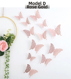 3D hollow rose gold butterfly wall stickers in various sizes on a white wall decor
