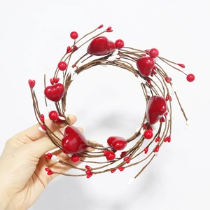 Detailed close-up of handmade red heart berry candle ring wreath with glossy finish