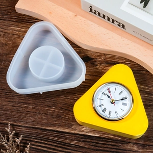Detail of bird house clock silicone mold and finished triangle desktop clock on wood