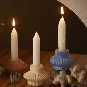 Close-up of geometric striped resin candle holders in various colors for DIY decor