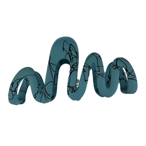 Matte teal wave hair claw clip with black abstract graffiti pattern on white background