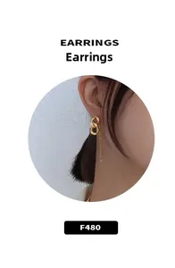 Close-up of bright gold-plated chain link earrings with long tassel detail for women