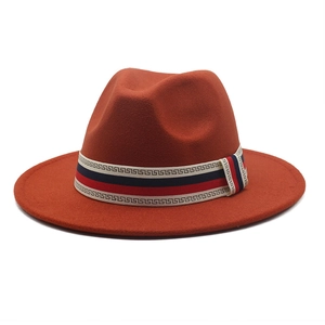 Detailed side view of caramel wool fedora with greek pattern ribbon and wide flat brim