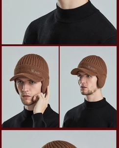 Detail of a brown knit winter hat with Sport logo, visor, and warm ear protection