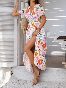 Detail of V-neck and high-waist elastic pleats on a floral print bohemian dress