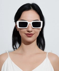 Close-up of model wearing white chunky rectangle sunglasses with black lenses for casual look