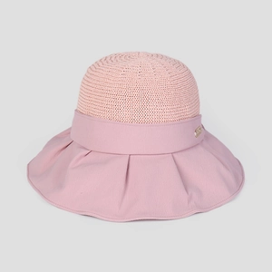 Detail of pink summer sun hat showing knit crown texture and wavy fabric brim with metal tag