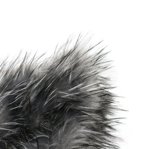 Macro shot of fluffy grey and white faux fox fur bucket hat showing soft long hair texture