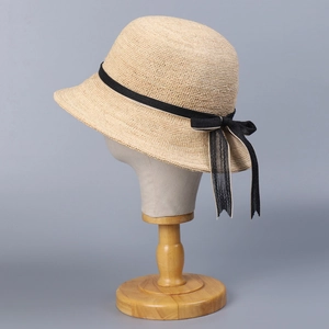 Handwoven raffia sun hat with dome top and elegant black ribbon bow detail
