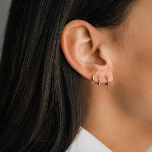 Minimalist gold S925 sterling silver hoop earrings shown on model for elegant style
