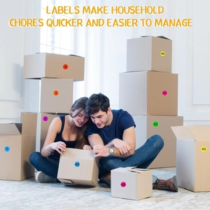 Couple using colorful numbered stickers to organize moving boxes for efficient labeling