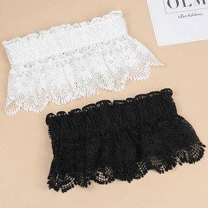Macro detail of elastic floral lace garters in black and white with ruffled edges