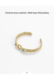 Close-up of gold snake texture cuff with blue stones and multi-layer plating