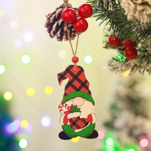 Detail view of a wooden gnome ornament with red plaid hat, pine cones and red berries