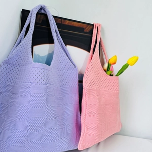 Detailed knit texture of pink and purple large capacity tote bags with floral accents