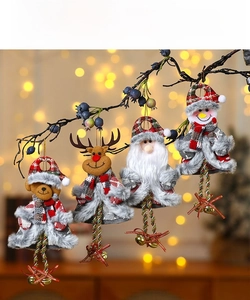 Close-up of Christmas plush ornaments featuring reindeer and snowman with bells and plaid decor