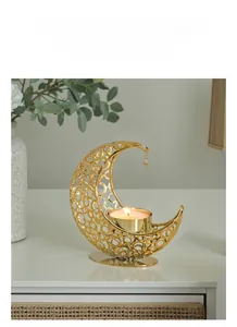 Detailed view of golden moon-shaped incense burner with hollow ring patterns and a star