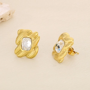 Macro shot of irregular gold base with clear square crystal inlay for elegant earring