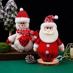 Close-up of knitted Santa and Snowman figures with festive holiday textures