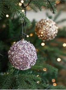 Detailed view of 8cm purple and gold Christmas balls with sequins and pearls on a tree