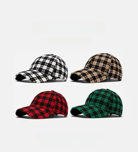 Detail view of four textured plaid baseball hats in black, red, green and brown colors