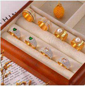 Luxurious gold rings with pearls and zircon set in an elegant wooden jewelry box