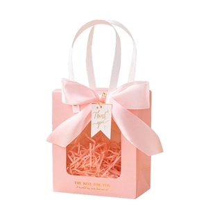 Pink paper gift bag with window, satin ribbon bow and 'Thank you' tag for luxury packaging