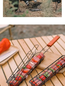 Outdoor BBQ grill basket with wooden handle filled with fresh meat and vegetables