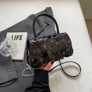 Detail of black sequined crossbody bag with top handle and elegant chain strap