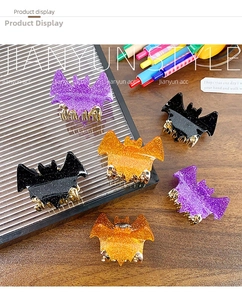 Detailed view of Halloween bat hair claws in black, purple and orange with glitter finish