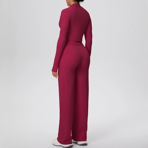 Detail of burgundy yoga set featuring slim-fit long sleeve top and high-waist wide-leg pants