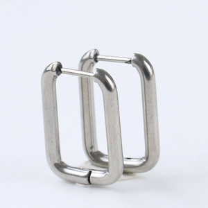 Close-up of polished silver stainless steel U-shaped rectangular hoop earrings on white