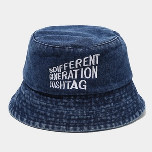 Detailed view of blue denim bucket hat featuring white embroidery and reinforced stitching