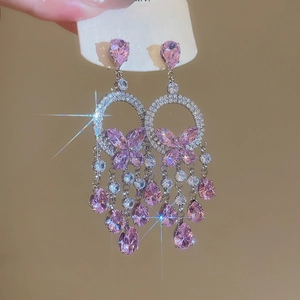 Detailed view of pink zircon long tassel earrings with butterfly design and shiny finish