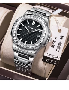 Macro shot of silver steel watch with crystal-encrusted bezel and black embossed dial