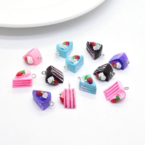 Macro view of colorful resin cake slices with cream and strawberry for DIY crafts