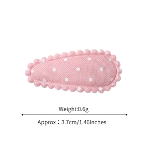 Pink polka dot fabric snap hair clip with wavy edges measuring 3.7cm for children